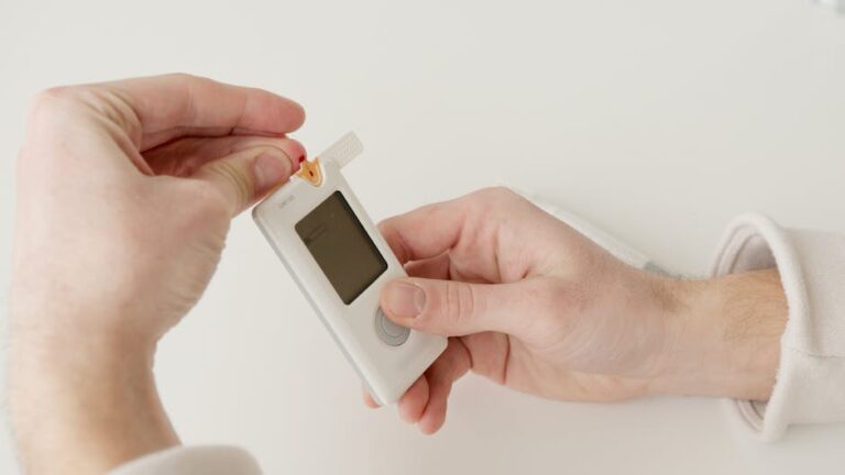 A person using a glucometer to check blood sugar levels for diabetes management.