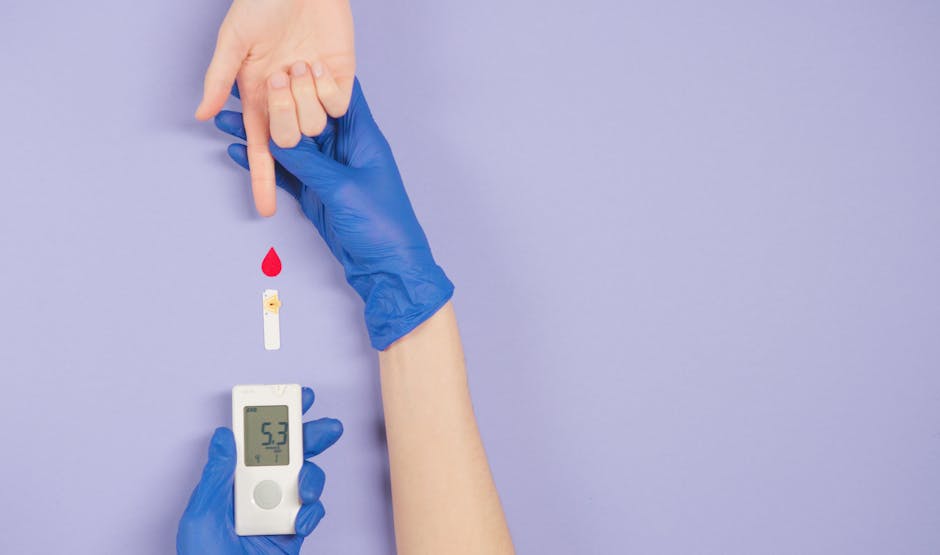 Gloved hand testing blood glucose level with meter and blood drop.