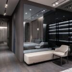 Interior design of bedroom with modern furniture and big mirror on wall in flat