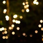 Soft-focus bokeh lights create a dreamy and festive night ambiance with warm hues.