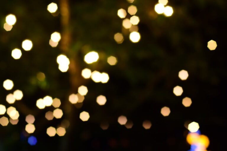 Soft-focus bokeh lights create a dreamy and festive night ambiance with warm hues.