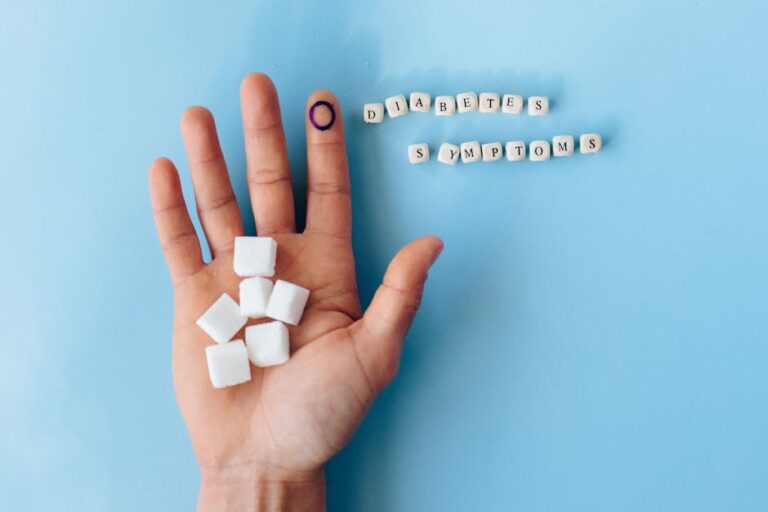 A hand holding sugar cubes with 'Diabetes Symptoms' spelled out, promoting awareness.