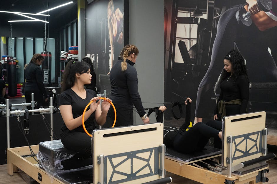 Women engaging in pilates exercises on reformers at a contemporary gym.