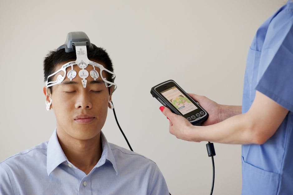 Healthcare professional conducting an EEG examination using a Brainscope device on a male patient.